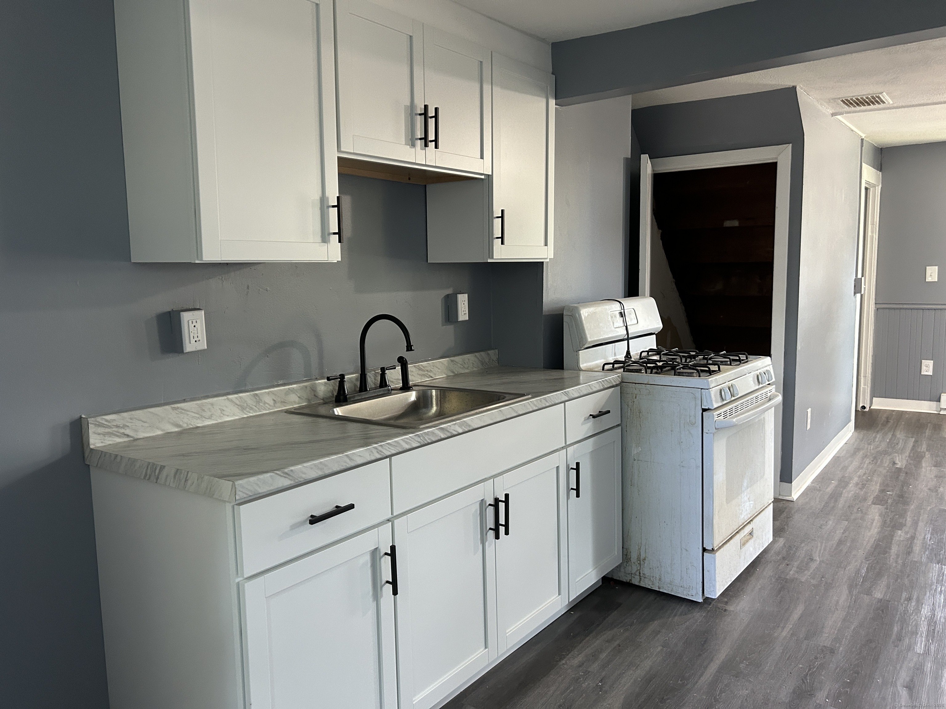 164 Central Avenue Norwich, CT 06360 - Photo 5 of 16 a kitchen with white cabinets and sink