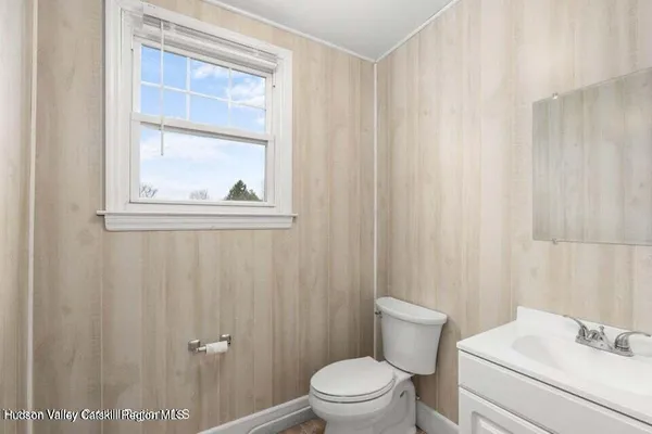a white toilet sitting next to a bathroom sink