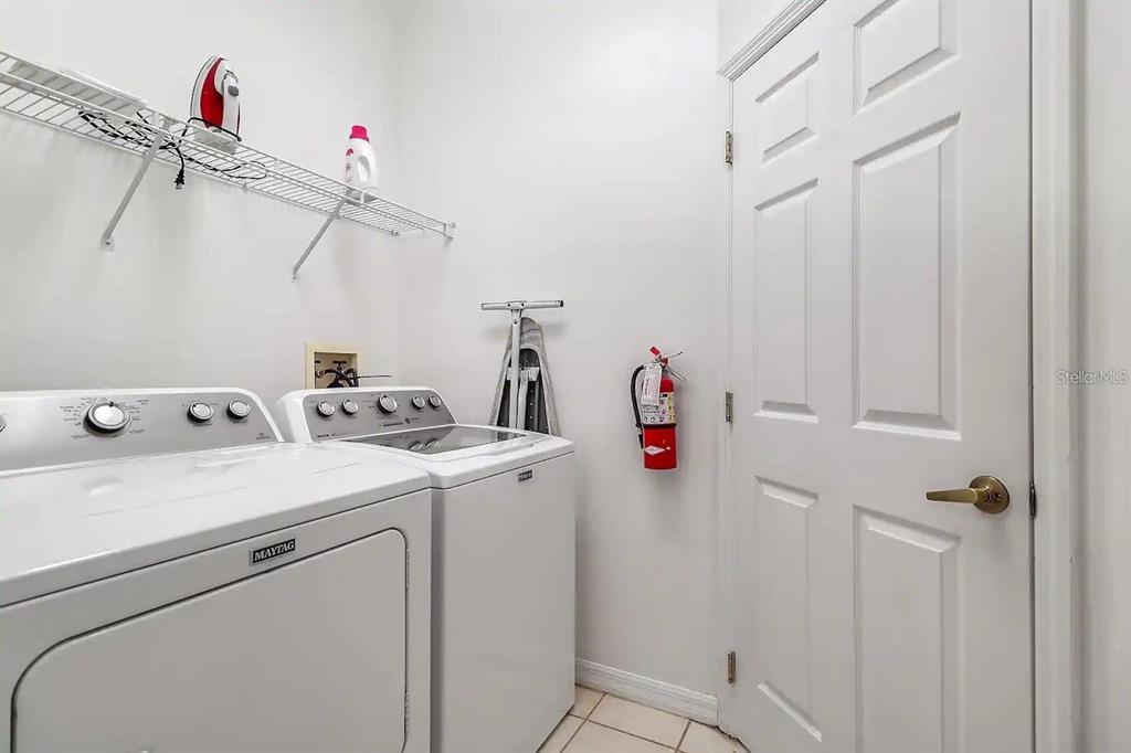 344 Grosvenor Loop Davenport, FL 33897 - Photo 12 of 27 a utility room with dryer and washer