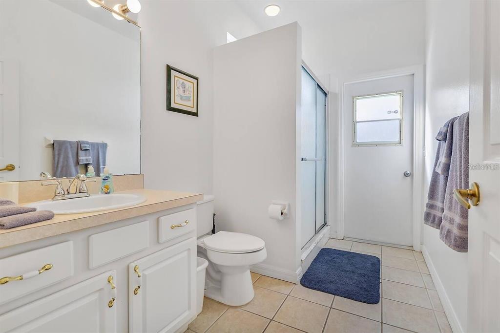 344 Grosvenor Loop Davenport, FL 33897 - Photo 14 of 27 a bathroom with a sink a toilet and shower