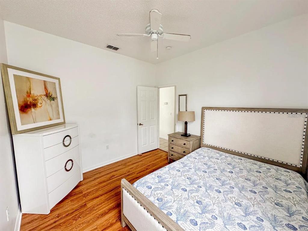 344 Grosvenor Loop Davenport, FL 33897 - Photo 22 of 27 a bedroom with a bed and a painting on the wall