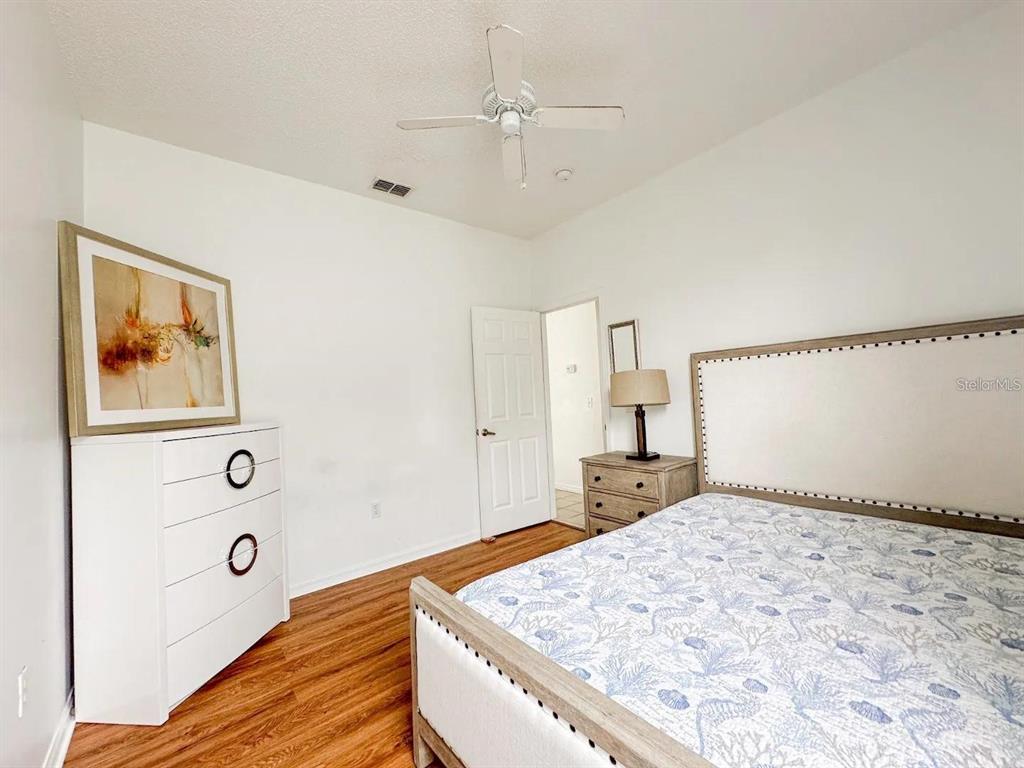 344 Grosvenor Loop Davenport, FL 33897 - Photo 23 of 27 a bedroom with a bed and a dresser