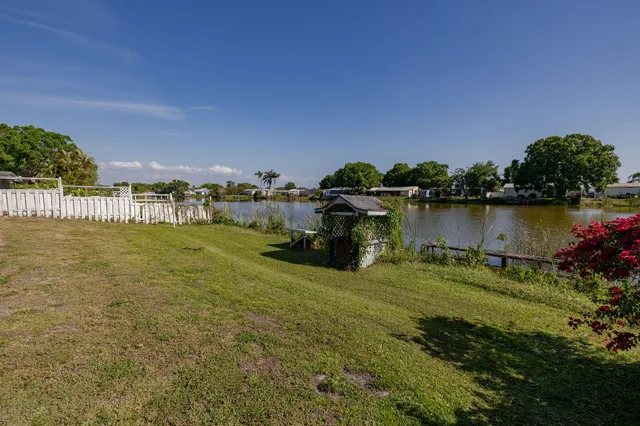 a view of a lake with houses in the back