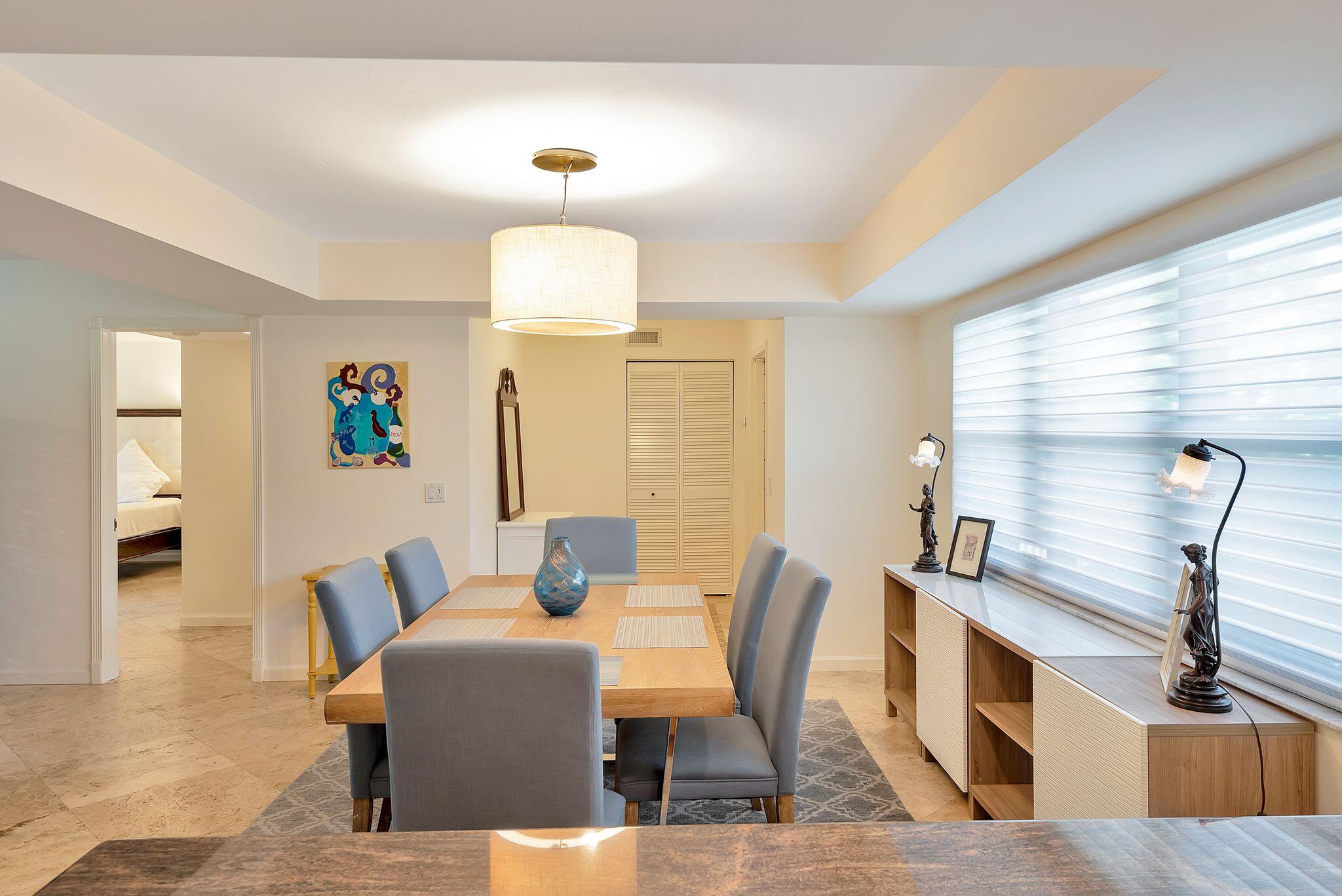 277 North Ocean Boulevard, Unit 2020 Boca Raton, FL 33432 - Photo 11 of 33 a view of a dining room with furniture and wooden floor