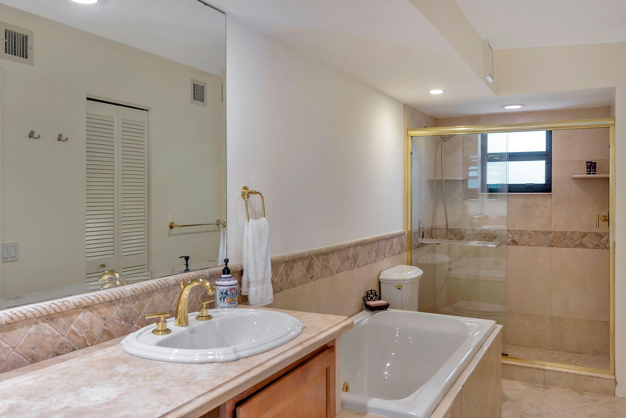 277 North Ocean Boulevard, Unit 2020 Boca Raton, FL 33432 - Photo 17 of 33 a bathroom with a sink and a mirror