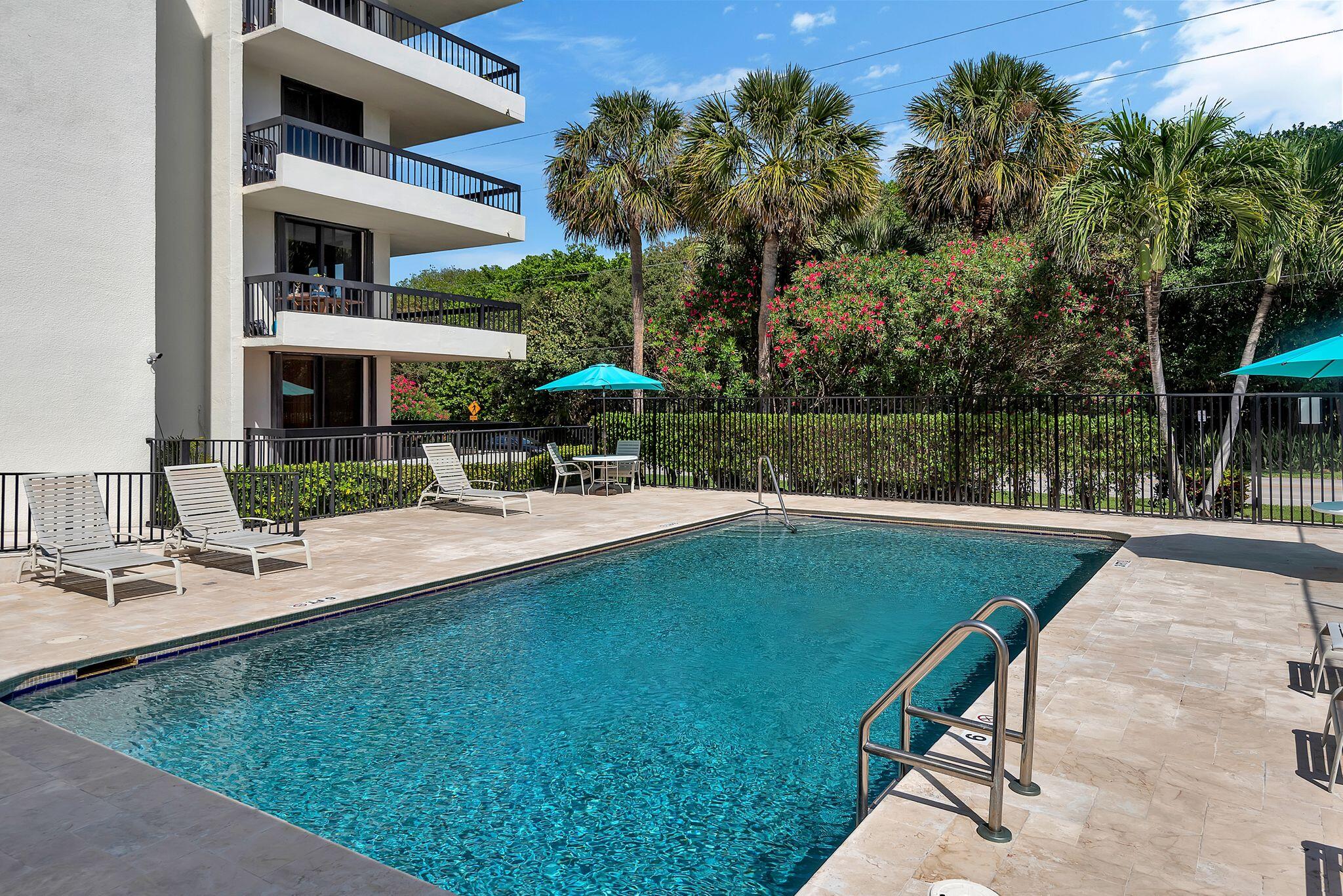 277 North Ocean Boulevard, Unit 2020 Boca Raton, FL 33432 - Photo 25 of 33 a view of a swimming pool with a patio