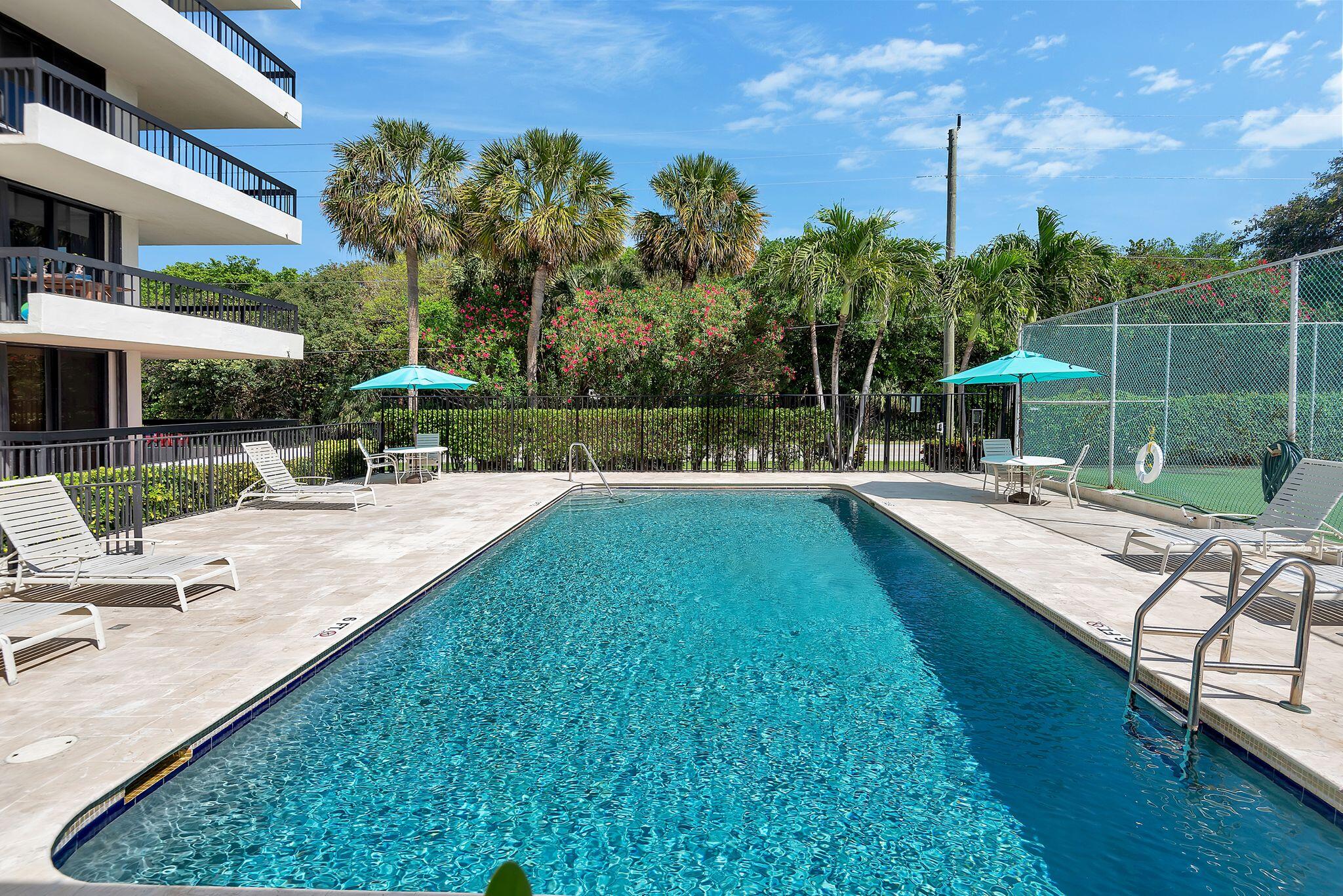 277 North Ocean Boulevard, Unit 2020 Boca Raton, FL 33432 - Photo 6 of 33 a view of a swimming pool with a patio