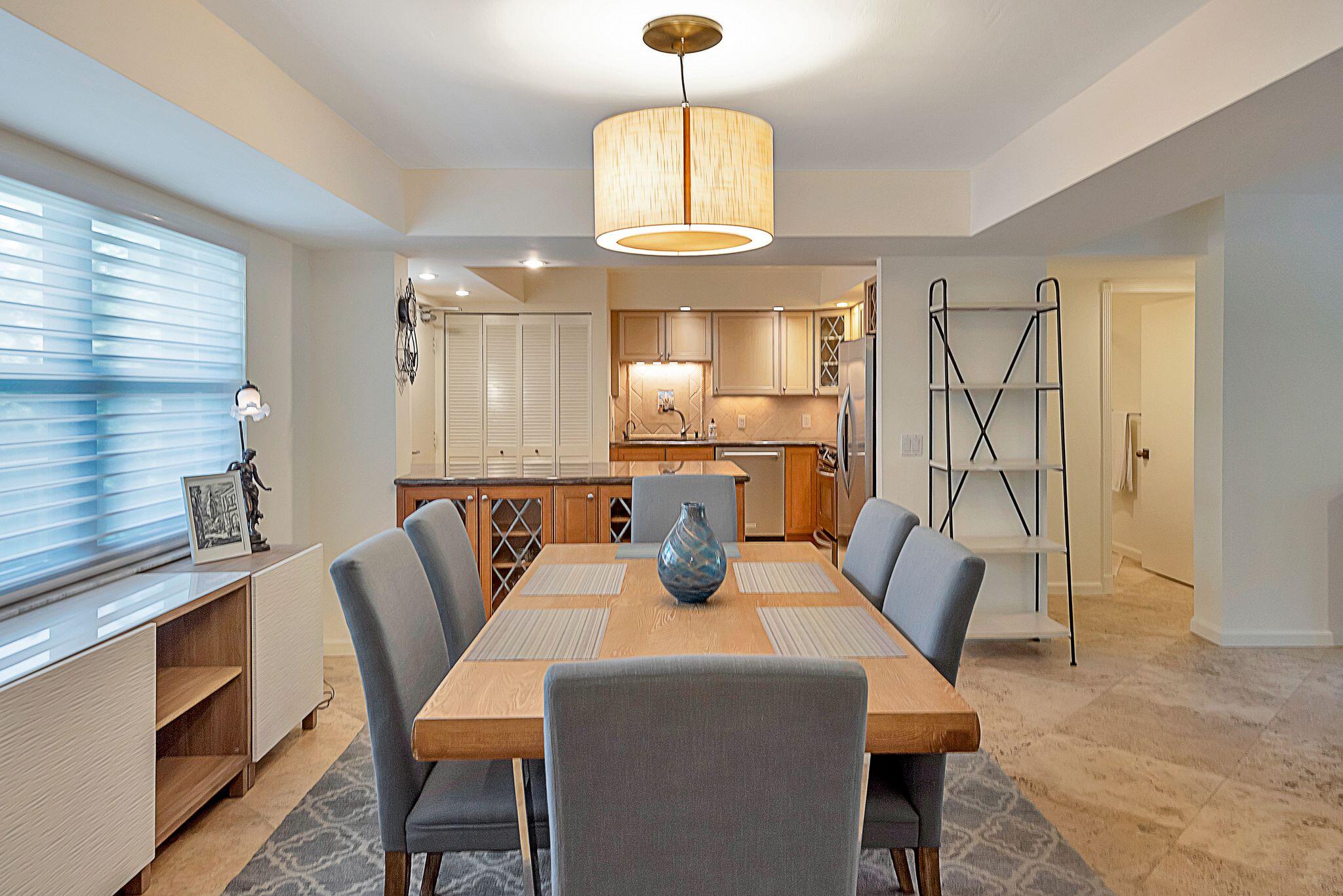 277 North Ocean Boulevard, Unit 2020 Boca Raton, FL 33432 - Photo 8 of 33 a view of a dining room with furniture window and wooden floor