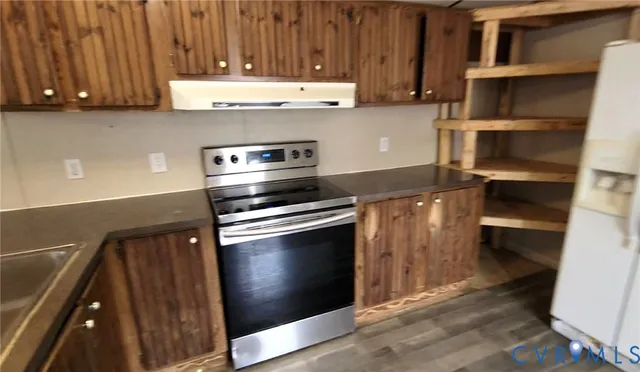 a kitchen with a stove and a refrigerator