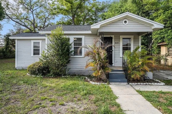 a front view of a house with a garden