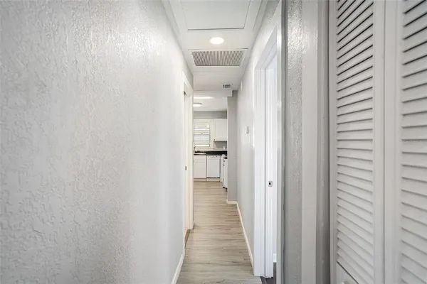 a view of hallway with wooden floor