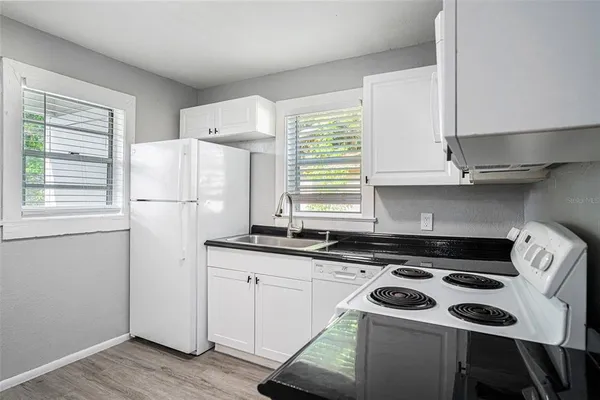 a kitchen with a stove a sink and a refrigerator