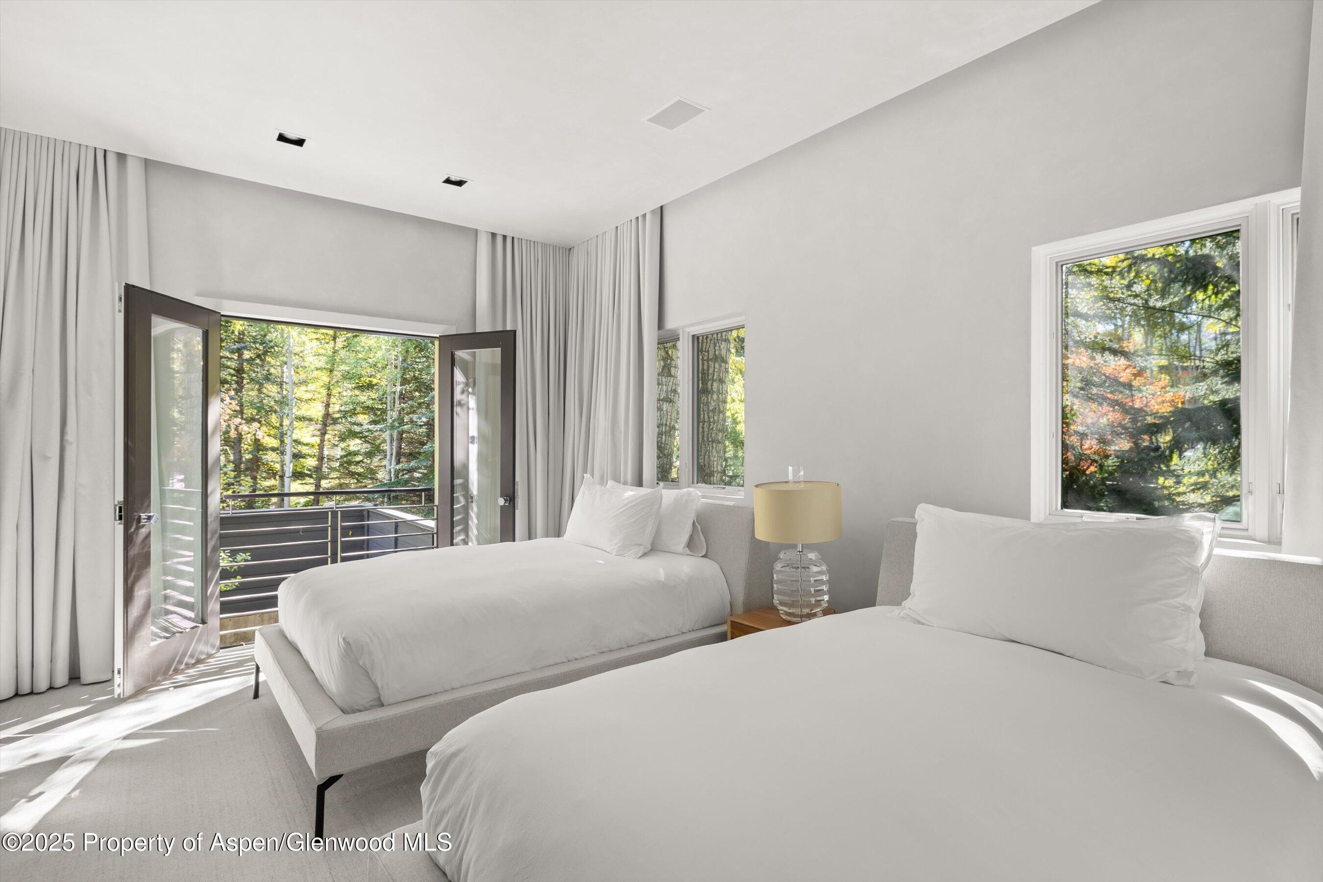 1220 Red Butte Drive Aspen, CO 81611 - Photo 19 of 27 a bedroom with two beds and a large window