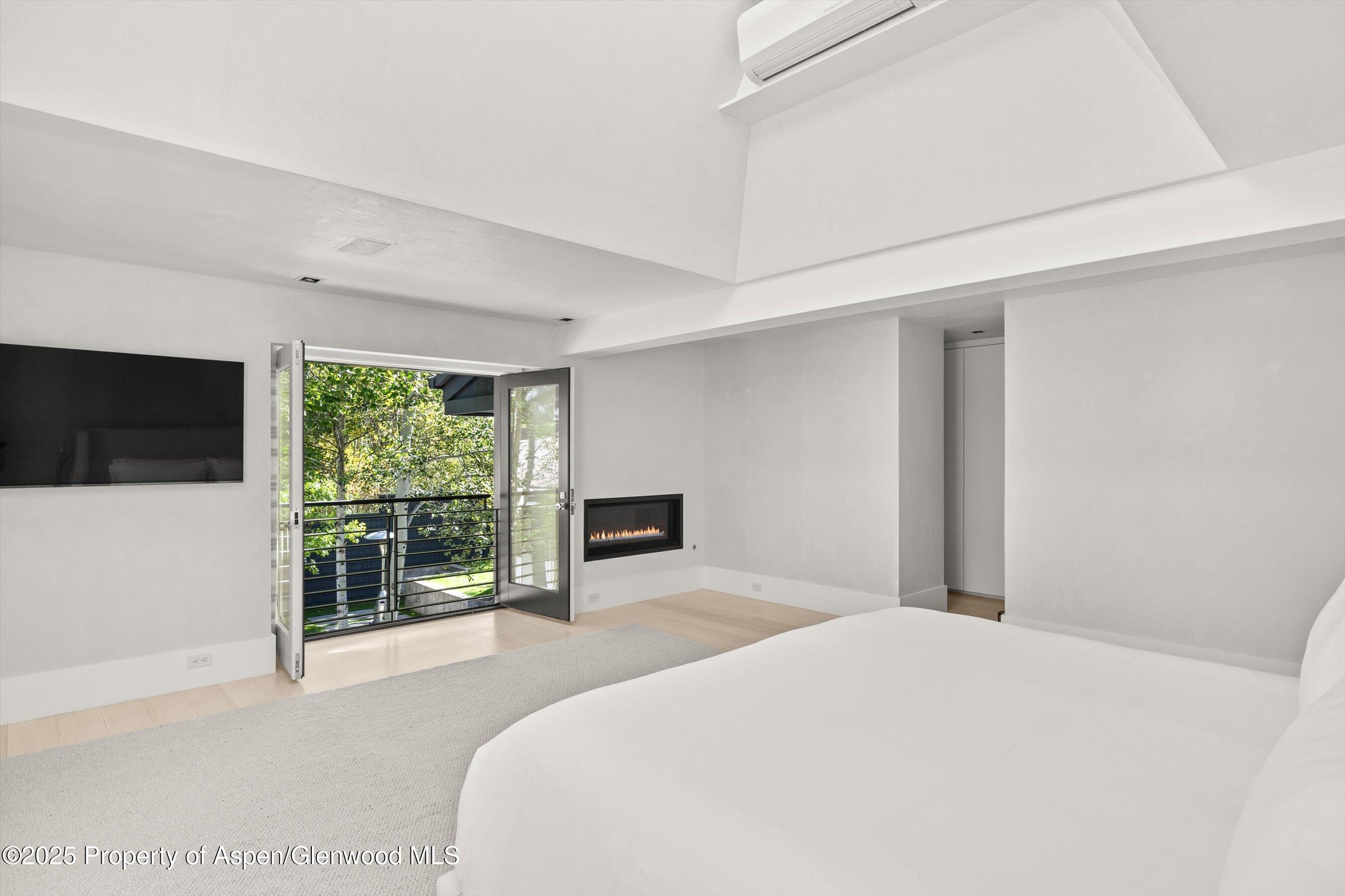 1220 Red Butte Drive Aspen, CO 81611 - Photo 21 of 27 a bedroom with a large bed and a flat tv screen