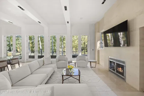 a living room with furniture a flat screen tv and a fireplace
