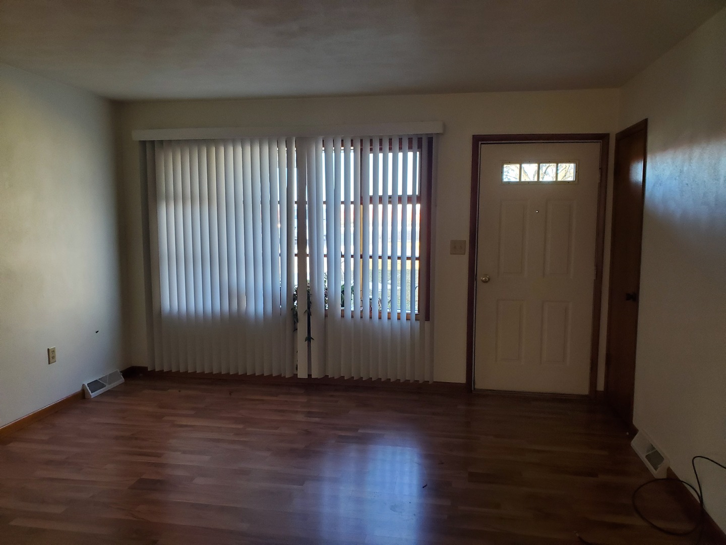730 North 2853rd Road Utica, IL 61373 - Photo 8 of 23 an empty room with wooden floor and windows