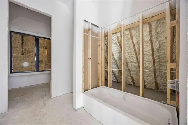 a bathroom with a tub and shower