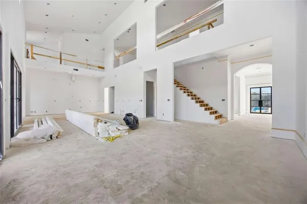 a view of a livingroom with furniture and staircase