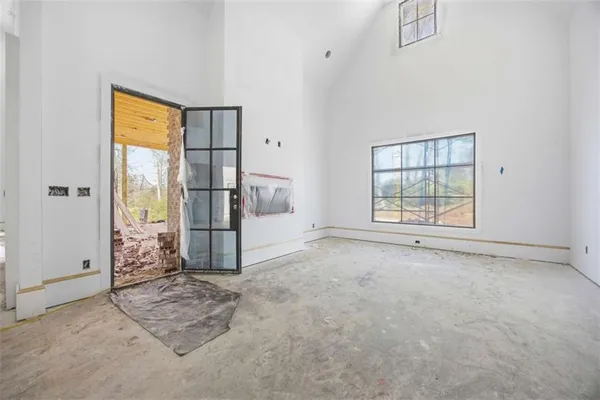 an empty room with windows and closet