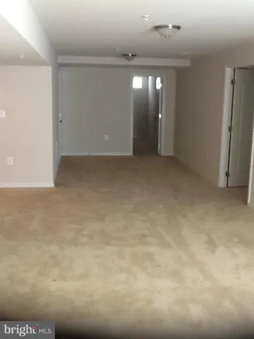an empty room with view of a bathroom