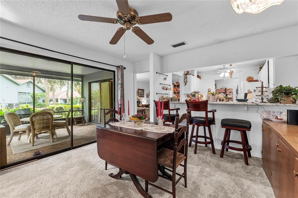 6642 Trail Ridge Drive, Unit 6642 Lakeland, FL 33813 - Photo 14 of 39 a view of a dining room with furniture window and outside view