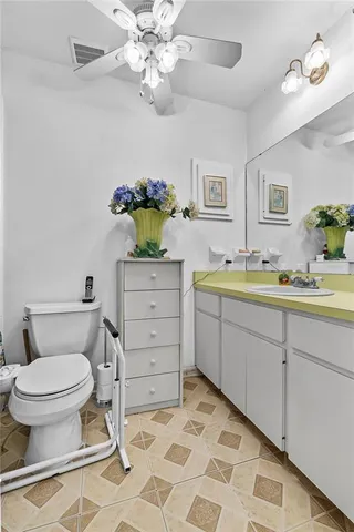 a bathroom with a sink toilet and a mirror