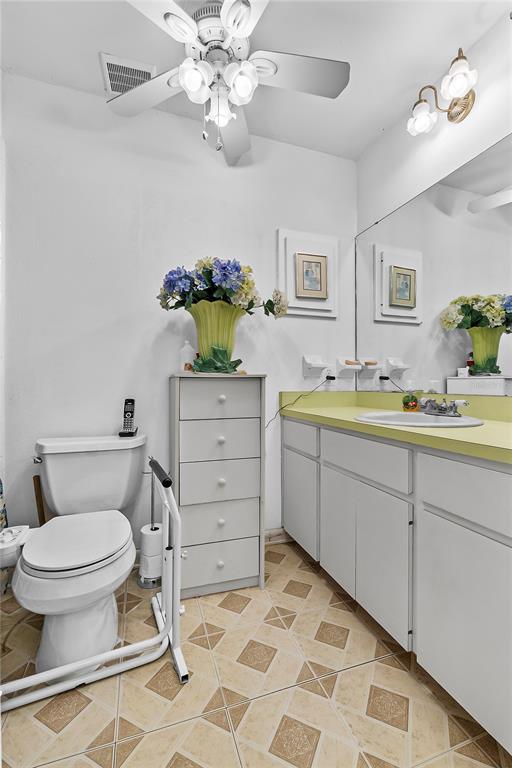 6642 Trail Ridge Drive, Unit 6642 Lakeland, FL 33813 - Photo 20 of 39 a bathroom with a sink toilet and a mirror