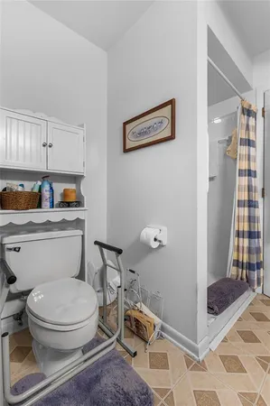 a white toilet sitting next to a bathroom sink