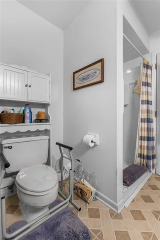 a white toilet sitting next to a bathroom sink