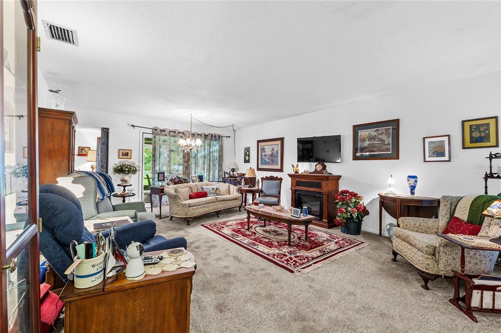 6642 Trail Ridge Drive, Unit 6642 Lakeland, FL 33813 - Photo 3 of 39 a living room with furniture and a flat screen tv