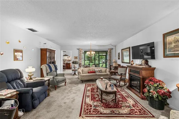a living room with furniture flat screen tv and a window