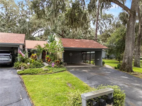 a front view of a house with a garden and sitting area