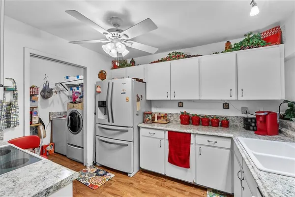 a kitchen with stainless steel appliances granite countertop a refrigerator sink and cabinets