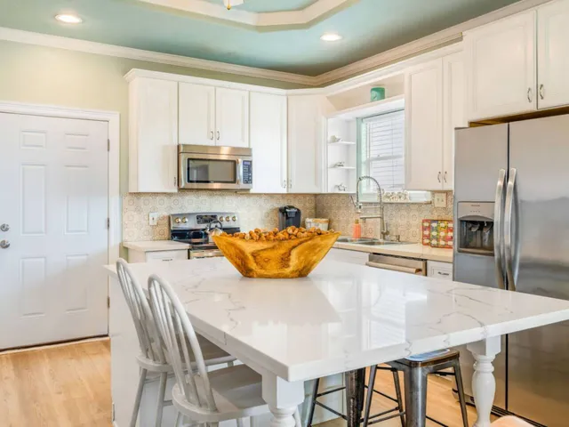 a kitchen with a stove a sink and a refrigerator