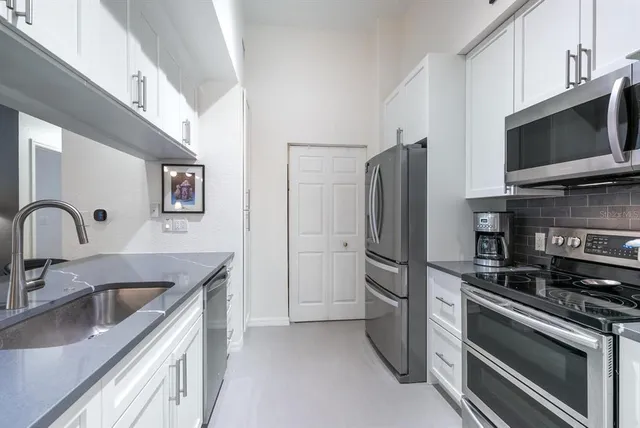 a kitchen with stainless steel appliances a refrigerator stove and sink
