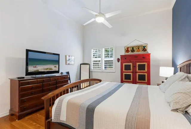 a bedroom with a bed and a flat screen tv