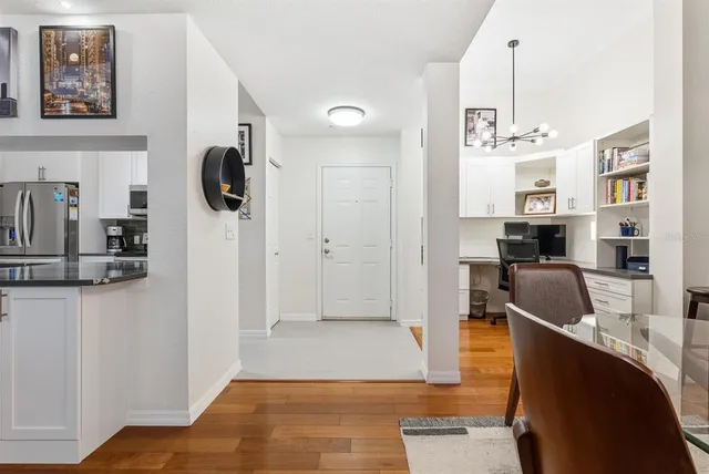 a kitchen with stainless steel appliances granite countertop a sink and a refrigerator