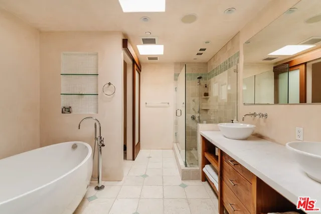 a bathroom with a granite countertop sink a toilet and shower