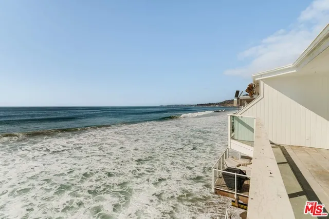 a vase of flowers sitting on a table in front of a window