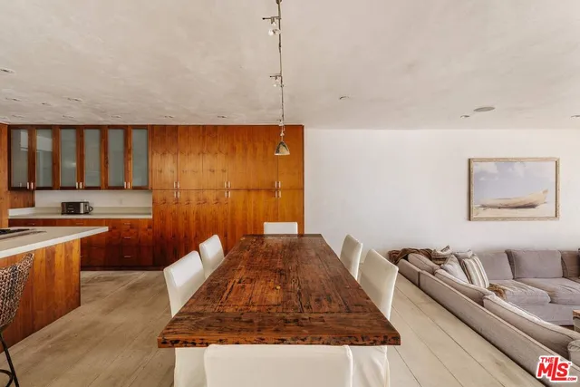 a living room with stainless steel appliances granite countertop furniture a rug a stove and a refrigerator