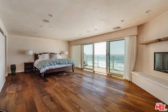 a spacious bedroom with a bed and a large window