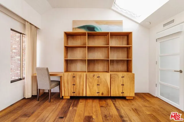 a view of room with wooden floor and furniture