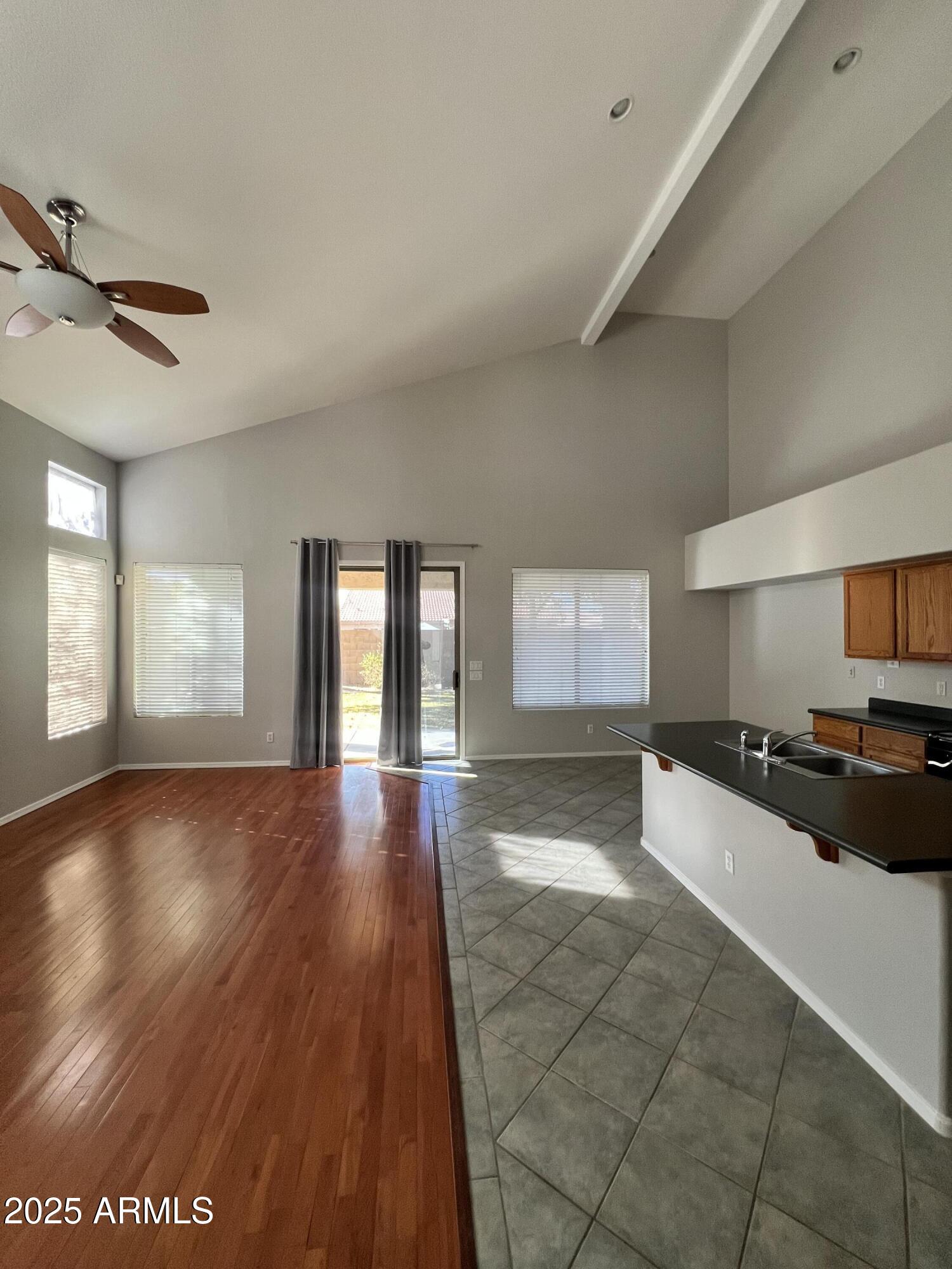 20582 North 92nd Lane Peoria, AZ 85382 - Photo 2 of 30 a large hall with wooden floor and cabinets