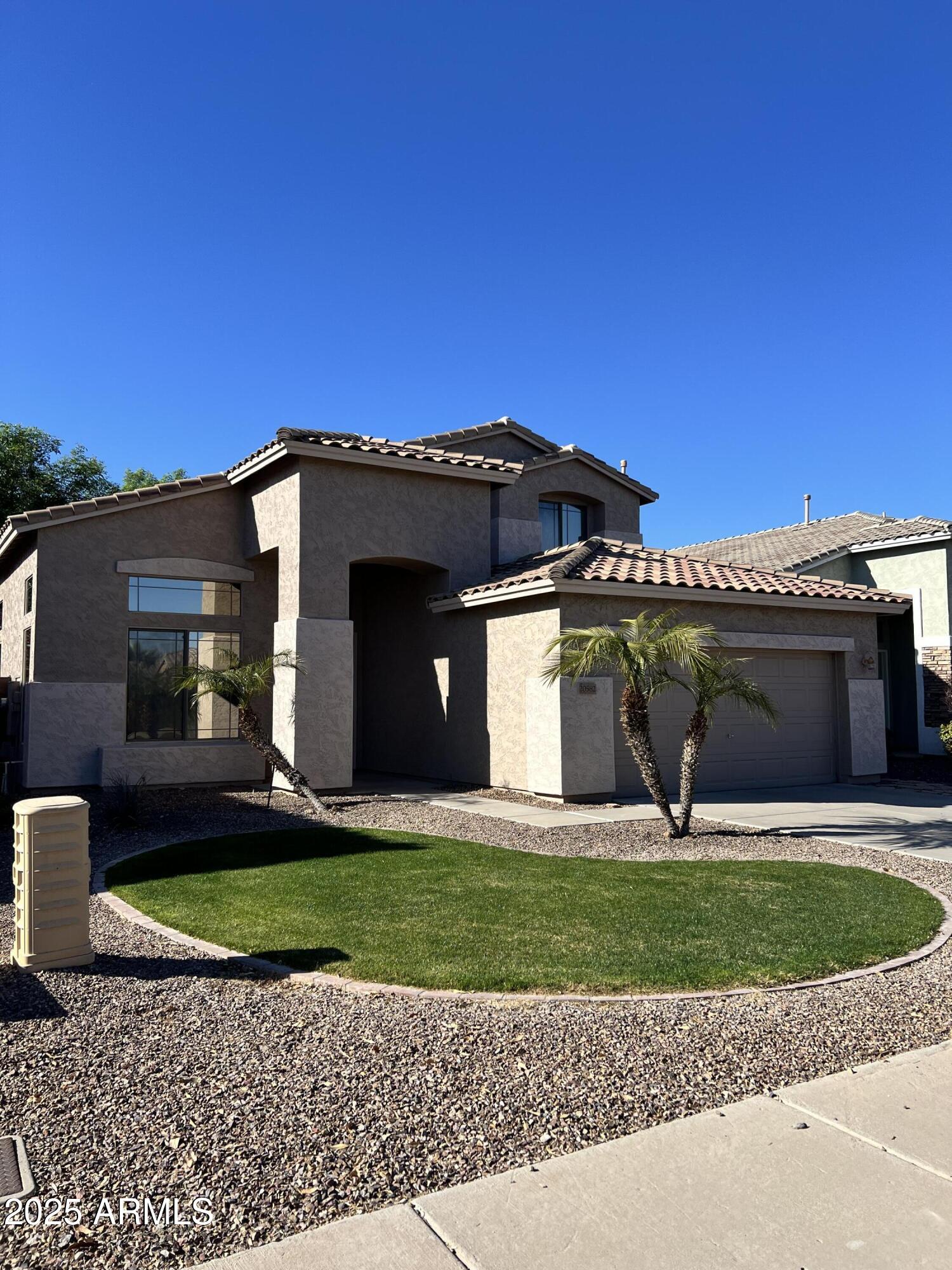 20582 North 92nd Lane Peoria, AZ 85382 - Photo 29 of 30 a front view of a house with a yard and garage