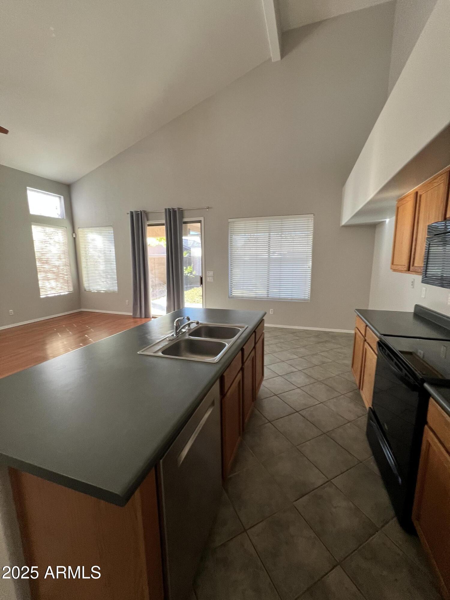 20582 North 92nd Lane Peoria, AZ 85382 - Photo 5 of 30 a kitchen with stainless steel appliances granite countertop a sink stove and cabinets