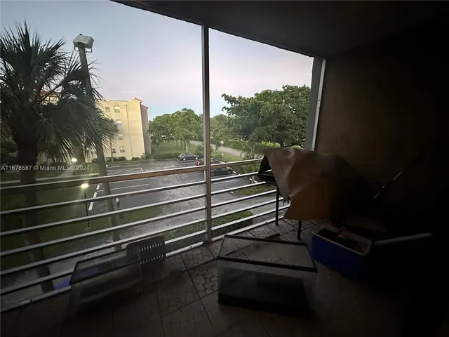 a view of a balcony with chairs and wooden floor