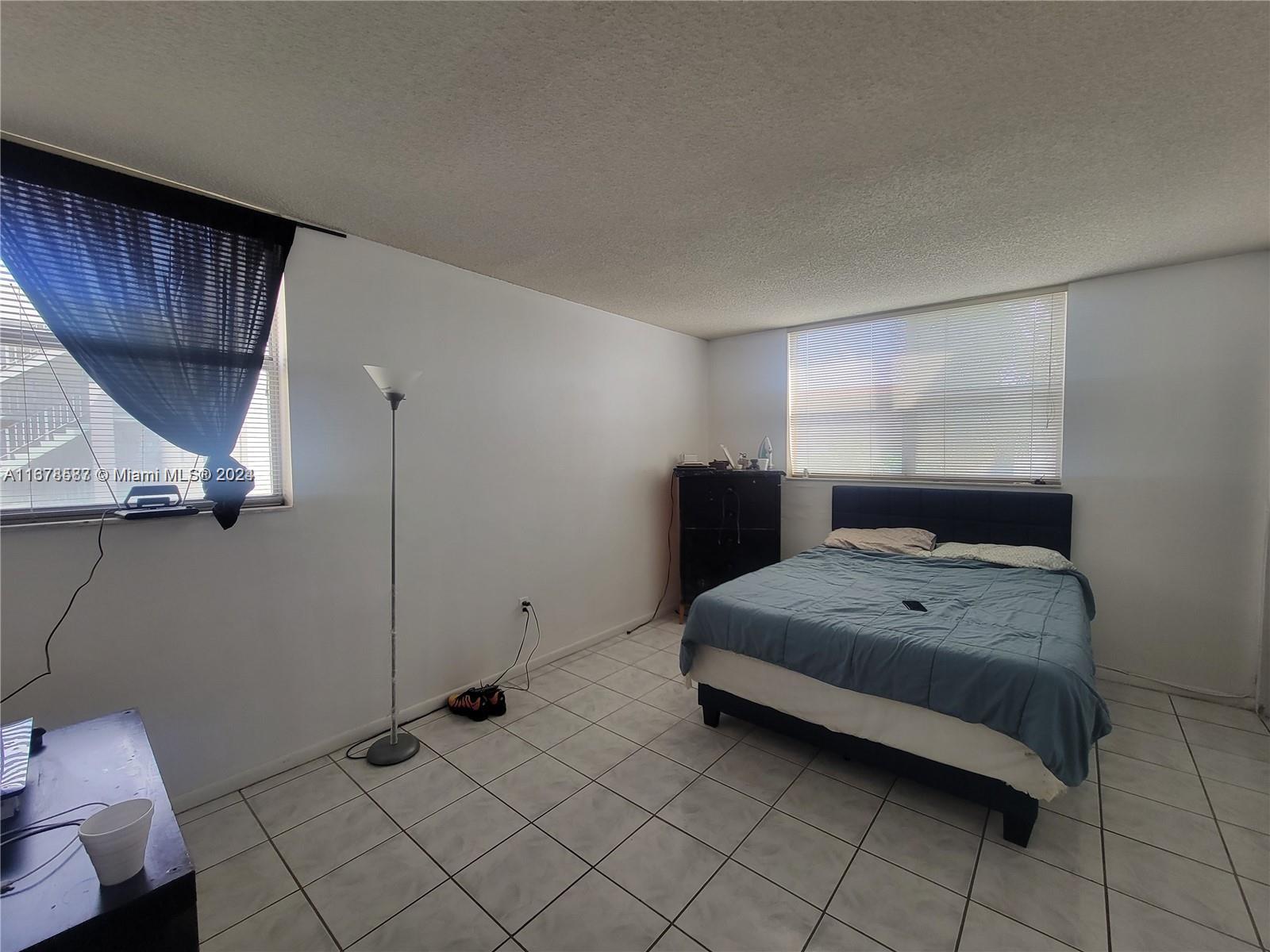 1820 Southwest 81st Avenue, Unit 3308 North Lauderdale, FL 33068 - Photo 40 of 49 a bedroom with a bed and a large window