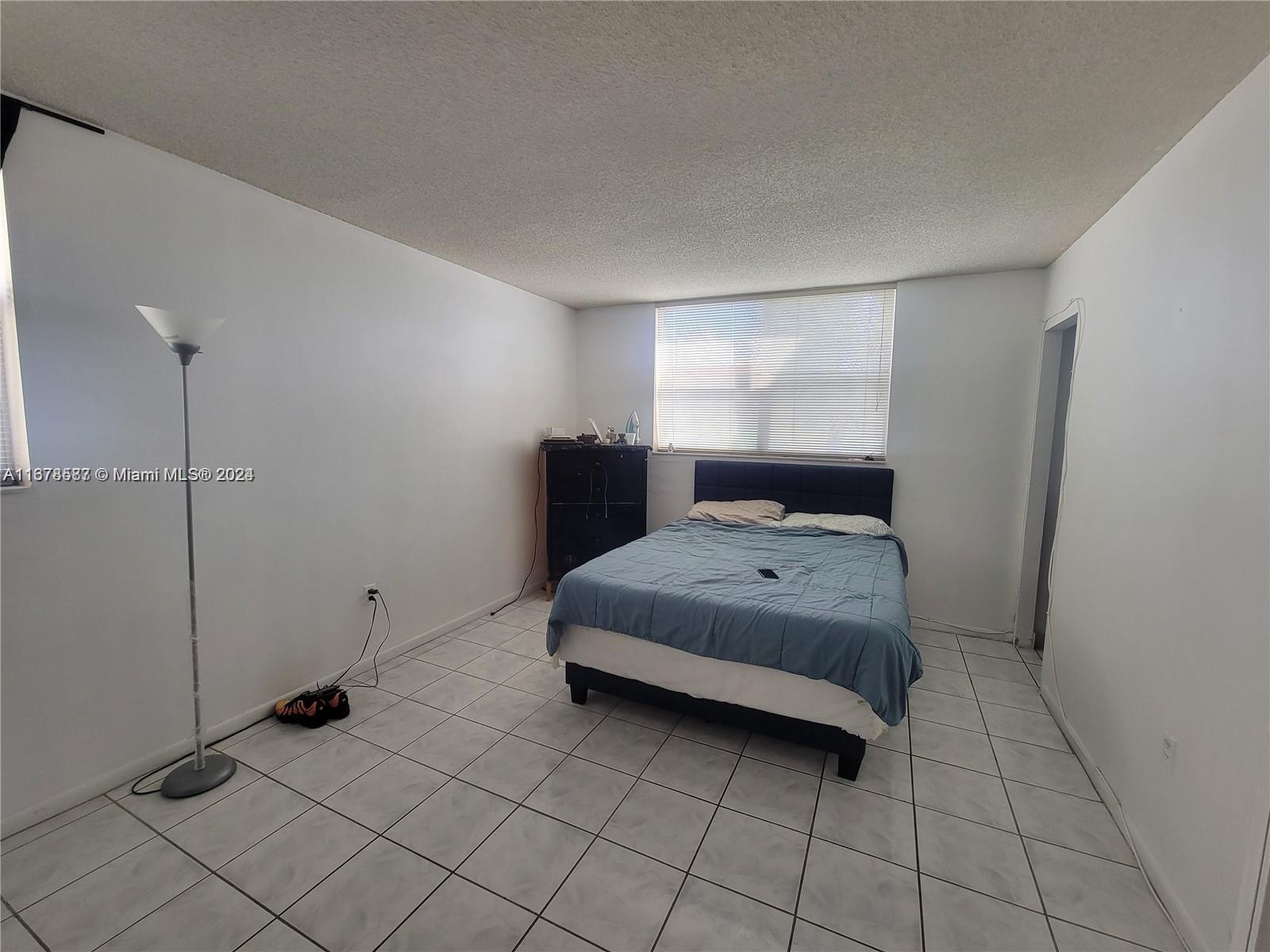1820 Southwest 81st Avenue, Unit 3308 North Lauderdale, FL 33068 - Photo 41 of 49 a bedroom with a bed and a window