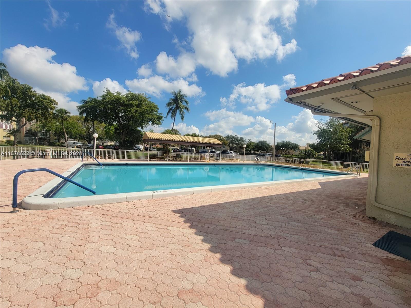 1820 Southwest 81st Avenue, Unit 3308 North Lauderdale, FL 33068 - Photo 48 of 49 a view of a swimming pool and a yard