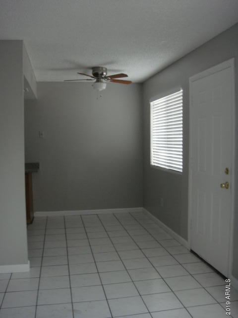 3315 West Loma Lane, Unit 4 Phoenix, AZ 85051 - Photo 1 of 13 a view of an empty room with a window